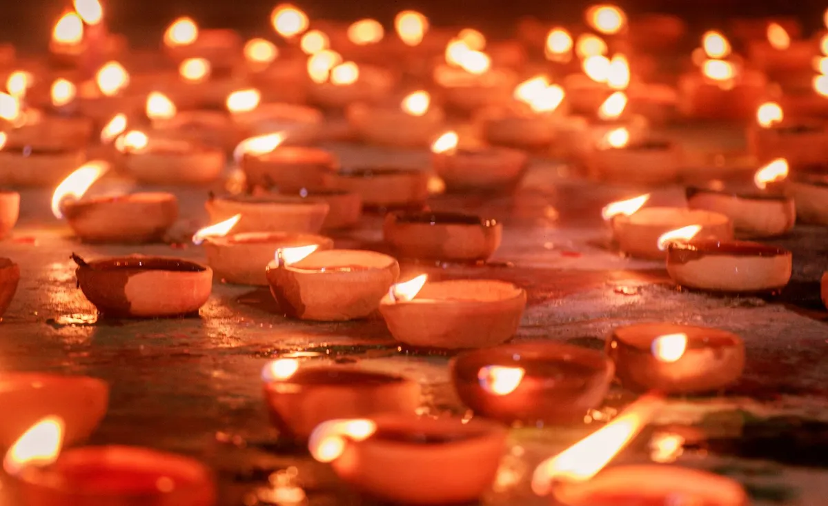 Traditional clay diyas glowing with warm light
